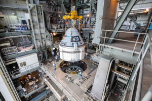Nov. 21, 2019 - The Boeing CST-100 Starliner spacecraft is guided into position above a ULA Atlas V rocket at the Vertical Integration Facility, Space Launch Complex 41, Florida’s Cape Canaveral Air Force Station. Credits: NASA/Cory Huston